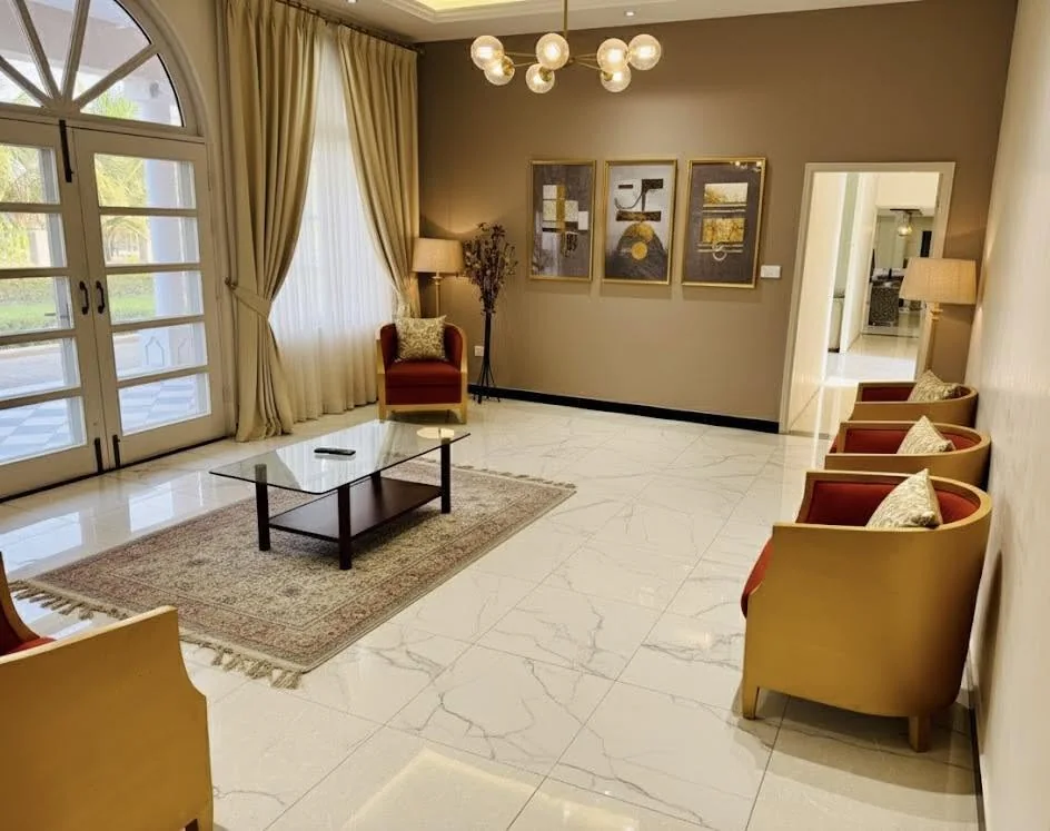 Bright resort lounge with marble floors, armchairs and garden doors